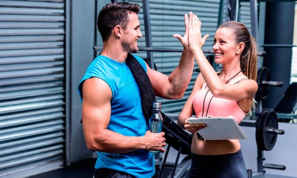 Cours avec un entraîneur dans la salle de sport pour filles. Quels sont les avantages individuels, collectifs et